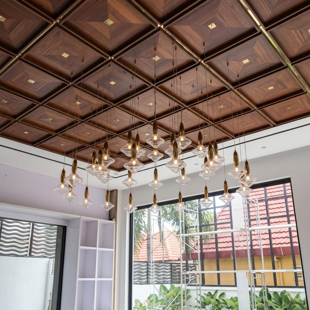 Clustered glass pendants beneath a coffered ceiling