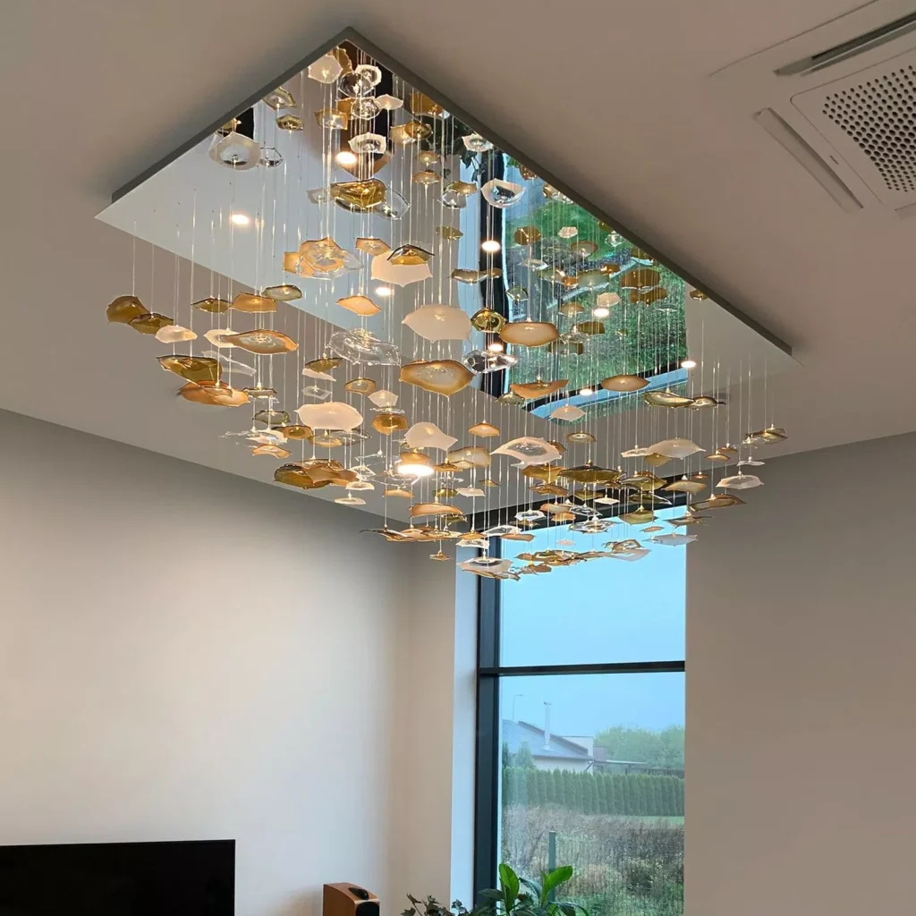Suspended glass elements beneath a rectangular mirrored canopy